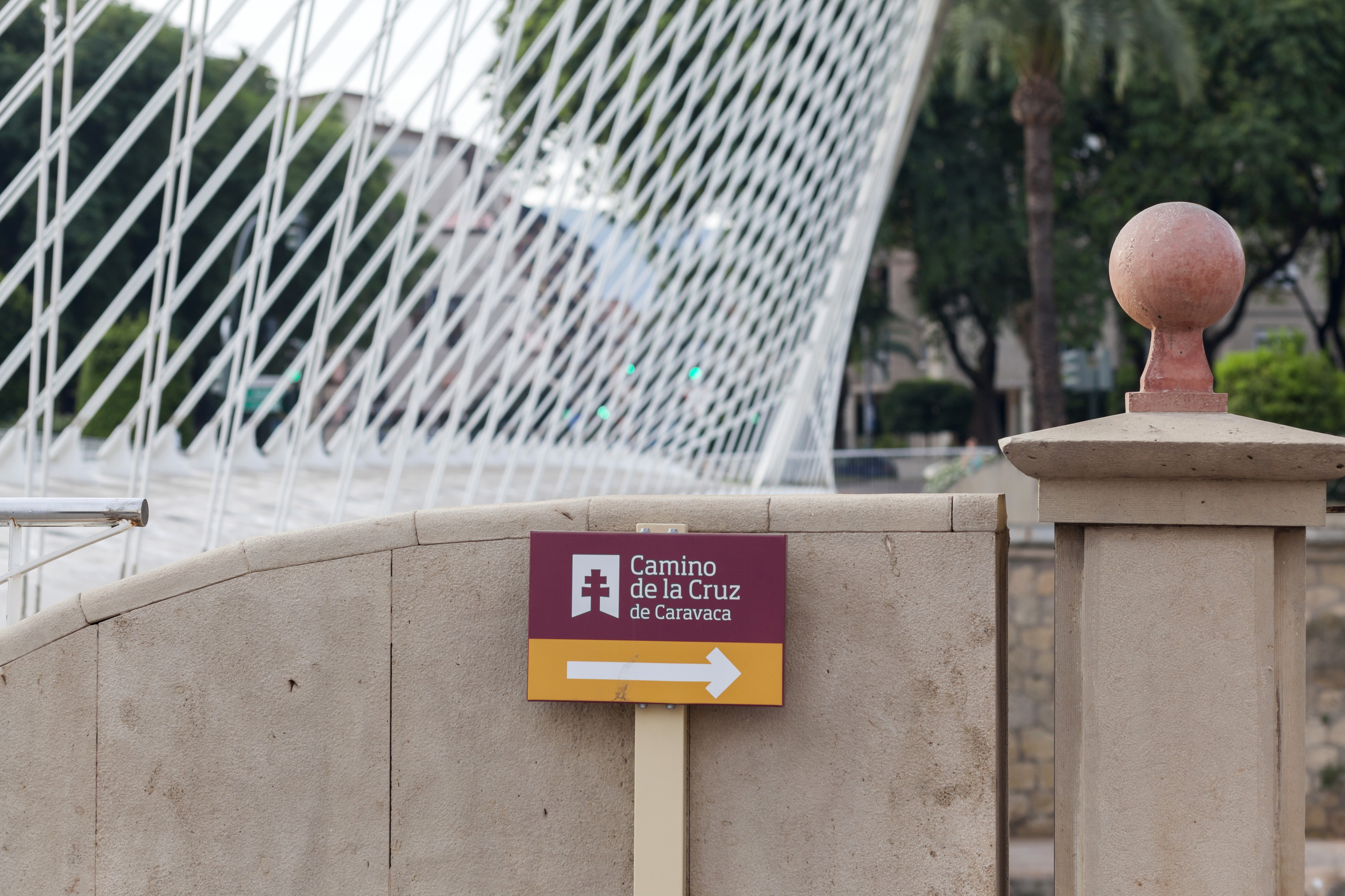 A Camino de la Cruz de Caravaca route sign beside a bridge in the Murcia region of Spain.